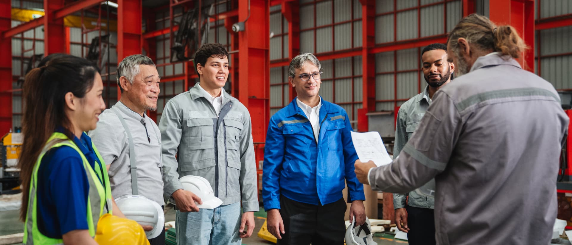 Engineers and foreman gathered for a meeting on the plant floor Engineers and foreman gathered for a meeting on the plant floor